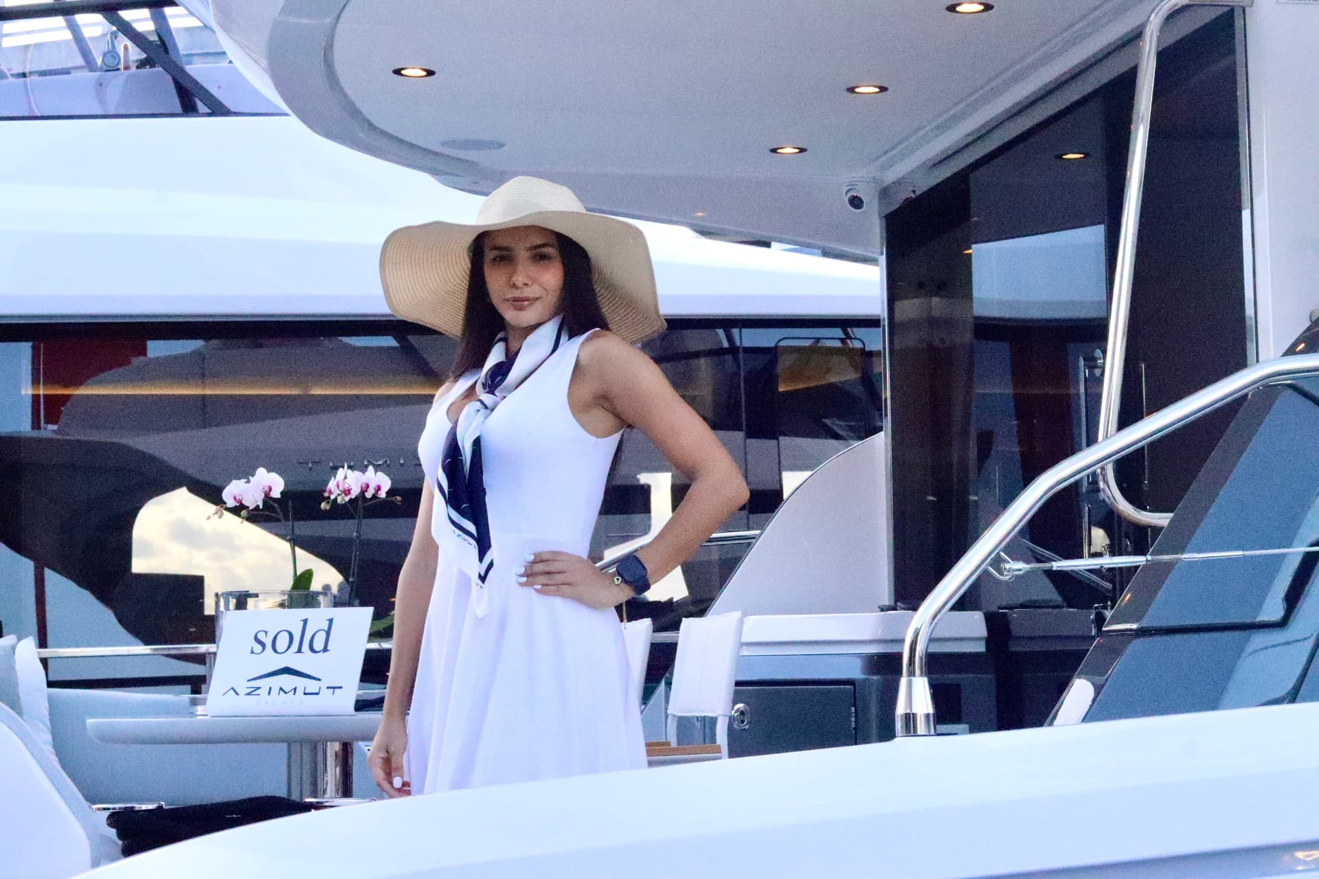 Show crew beside a sold Azimut yacht